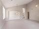 Open-concept living room with high ceilings, large archways, and neutral decor at 15229 S 18Th Dr, Phoenix, AZ 85045