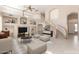 Bright, open living room with high ceilings, curved staircase, and built-in shelves at 15229 S 18Th Dr, Phoenix, AZ 85045