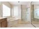 Bright main bathroom with a soaking tub, shower, and tile surround at 15229 S 18Th Dr, Phoenix, AZ 85045