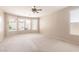 Bright main bedroom with a ceiling fan, carpet, and a bay window at 15229 S 18Th Dr, Phoenix, AZ 85045