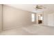 Neutral-colored main bedroom with light carpet and an arched entryway to the bathroom at 15229 S 18Th Dr, Phoenix, AZ 85045