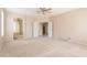 Main bedroom with neutral walls, light carpet, and arched entryway leading to the main bathroom at 15229 S 18Th Dr, Phoenix, AZ 85045