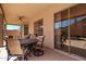 Inviting covered patio with comfortable seating, perfect for outdoor dining and relaxation with a view of the pool at 15229 S 18Th Dr, Phoenix, AZ 85045