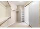Walk-in closet with carpeted floors, white shelving, and sliding doors at 15229 S 18Th Dr, Phoenix, AZ 85045