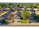 Beautiful aerial view of a two-story home with lush landscaping, a tidy lawn, and a quaint barrel palm at 1750 E Erie St, Gilbert, AZ 85295