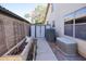 Home's backyard featuring a storage shed, A/C unit, and concrete walkway at 1750 E Erie St, Gilbert, AZ 85295