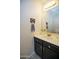 Stylish powder room with a modern vanity, decorative mirror, and chic patterned flooring at 1750 E Erie St, Gilbert, AZ 85295