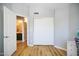 Neutral bedroom with closet, open door to bathroom, and wood flooring at 1750 E Erie St, Gilbert, AZ 85295