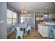 Inviting dining space with natural light, white cabinets, and stainless steel appliances visible in the kitchen at 1750 E Erie St, Gilbert, AZ 85295