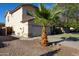 Charming two-story home featuring a xeriscaped yard and a neatly maintained lawn and a barrel palm at 1750 E Erie St, Gilbert, AZ 85295