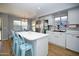 Well-lit kitchen with white cabinets, stainless appliances, and a view to the backyard at 1750 E Erie St, Gilbert, AZ 85295