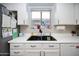 Kitchen sink with white countertops and cabinets providing a clean aesthetic at 1750 E Erie St, Gilbert, AZ 85295