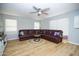 Spacious living room features a cozy sectional, ceiling fan, and lots of natural light at 1750 E Erie St, Gilbert, AZ 85295