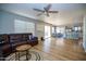 Inviting living room featuring a cozy leather sectional and bright, open floor plan with light wood flooring at 1750 E Erie St, Gilbert, AZ 85295