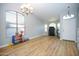 Bright and airy living room featuring a large window, neutral walls, and wood-look flooring at 1750 E Erie St, Gilbert, AZ 85295