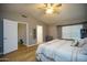 Bright main bedroom with a large window, a ceiling fan, and a hallway leading to other rooms at 1750 E Erie St, Gilbert, AZ 85295