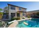 View of the backyard's in-ground pool, home, and covered patio at 1750 E Erie St, Gilbert, AZ 85295