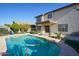 Full in-ground swimming pool surrounded by lush landscaping in the backyard at 1750 E Erie St, Gilbert, AZ 85295