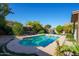 Beautiful swimming pool in the backyard with table and chairs for poolside entertaining at 1750 E Erie St, Gilbert, AZ 85295