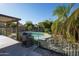 Backyard view of a private pool surrounded by lush landscaping and iron fencing at 1750 E Erie St, Gilbert, AZ 85295
