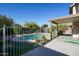 Fenced backyard view of the lovely in-ground pool with landscaping, patio and home at 1750 E Erie St, Gilbert, AZ 85295
