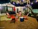 This backyard retreat has string lights, comfortable seating, artificial grass, and a modern fire pit at 1801 N 87Th Pl, Scottsdale, AZ 85257