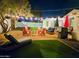 This backyard retreat has string lights, comfortable seating, artificial grass, and a modern fire pit at 1801 N 87Th Pl, Scottsdale, AZ 85257