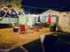 This backyard retreat has string lights, comfortable seating, artificial grass, and a modern fire pit at 1801 N 87Th Pl, Scottsdale, AZ 85257