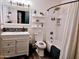 Well-lit bathroom featuring a vanity with storage, a mosaic backsplash, and a shower-tub combination at 1801 N 87Th Pl, Scottsdale, AZ 85257