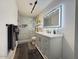 Modern bathroom featuring a lighted mirror, white vanity, and a walk-in shower at 1801 N 87Th Pl, Scottsdale, AZ 85257