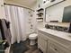 Well-lit bathroom featuring a tub and shower combo, single sink vanity, and stylish decor at 1801 N 87Th Pl, Scottsdale, AZ 85257