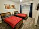 Cozy bedroom with two twin beds, soft carpeting, and ample natural light, offering a comfortable retreat at 1801 N 87Th Pl, Scottsdale, AZ 85257