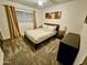 Bedroom featuring a queen size bed, neutral paint, carpet, and window with curtains at 1801 N 87Th Pl, Scottsdale, AZ 85257