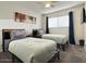 Cozy bedroom with two twin beds, a ceiling fan and neutral decor at 1801 N 87Th Pl, Scottsdale, AZ 85257