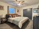 Comfortable bedroom featuring a ceiling fan, a queen bed, and soft neutral light at 1801 N 87Th Pl, Scottsdale, AZ 85257