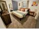 Cozy bedroom with a queen size bed, carpeted floors, and a stylish color scheme at 1801 N 87Th Pl, Scottsdale, AZ 85257