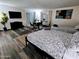 Spacious bedroom with two beds, modern decor, wood floors, and sliding glass door at 1801 N 87Th Pl, Scottsdale, AZ 85257
