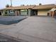 Exterior view of a single story home with a carport and tidy desert landscaping at 1801 N 87Th Pl, Scottsdale, AZ 85257