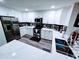 Updated kitchen featuring all white cabinets, stainless steel appliances, and light countertops at 1801 N 87Th Pl, Scottsdale, AZ 85257
