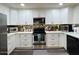 Well-lit kitchen showcases stainless steel appliances and sleek white cabinetry at 1801 N 87Th Pl, Scottsdale, AZ 85257