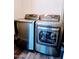 Laundry area with modern front-load washer and dryer set on a wood floor at 1801 N 87Th Pl, Scottsdale, AZ 85257