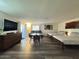 Open living area with two beds, a round table, seating area, and large television set at 1801 N 87Th Pl, Scottsdale, AZ 85257