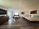 Spacious living area with two beds, a round table, seating area, and large television set at 1801 N 87Th Pl, Scottsdale, AZ 85257