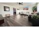 Comfortable living room featuring hardwood floors, ceiling fan, and neutral decor at 1801 N 87Th Pl, Scottsdale, AZ 85257