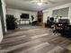 Spacious living area with a fireplace, ample seating, and stylish flooring, creating a cozy atmosphere at 1801 N 87Th Pl, Scottsdale, AZ 85257