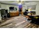 A spacious living room with an adjacent brick fireplace, modern ceiling fan, and dining area at 1801 N 87Th Pl, Scottsdale, AZ 85257
