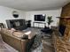 Comfortable living room featuring a stylish rug, brick fireplace, and entertainment center at 1801 N 87Th Pl, Scottsdale, AZ 85257