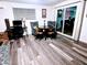 Living area featuring hardwood floors, a small table with four chairs, desk, and sliding glass door at 1801 N 87Th Pl, Scottsdale, AZ 85257