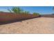 Spacious backyard with block wall providing privacy and clear blue skies above at 18047 W Long Lake Rd, Goodyear, AZ 85338