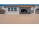 Backyard patio view featuring a sliding glass door, windows, and block wall at 18047 W Long Lake Rd, Goodyear, AZ 85338